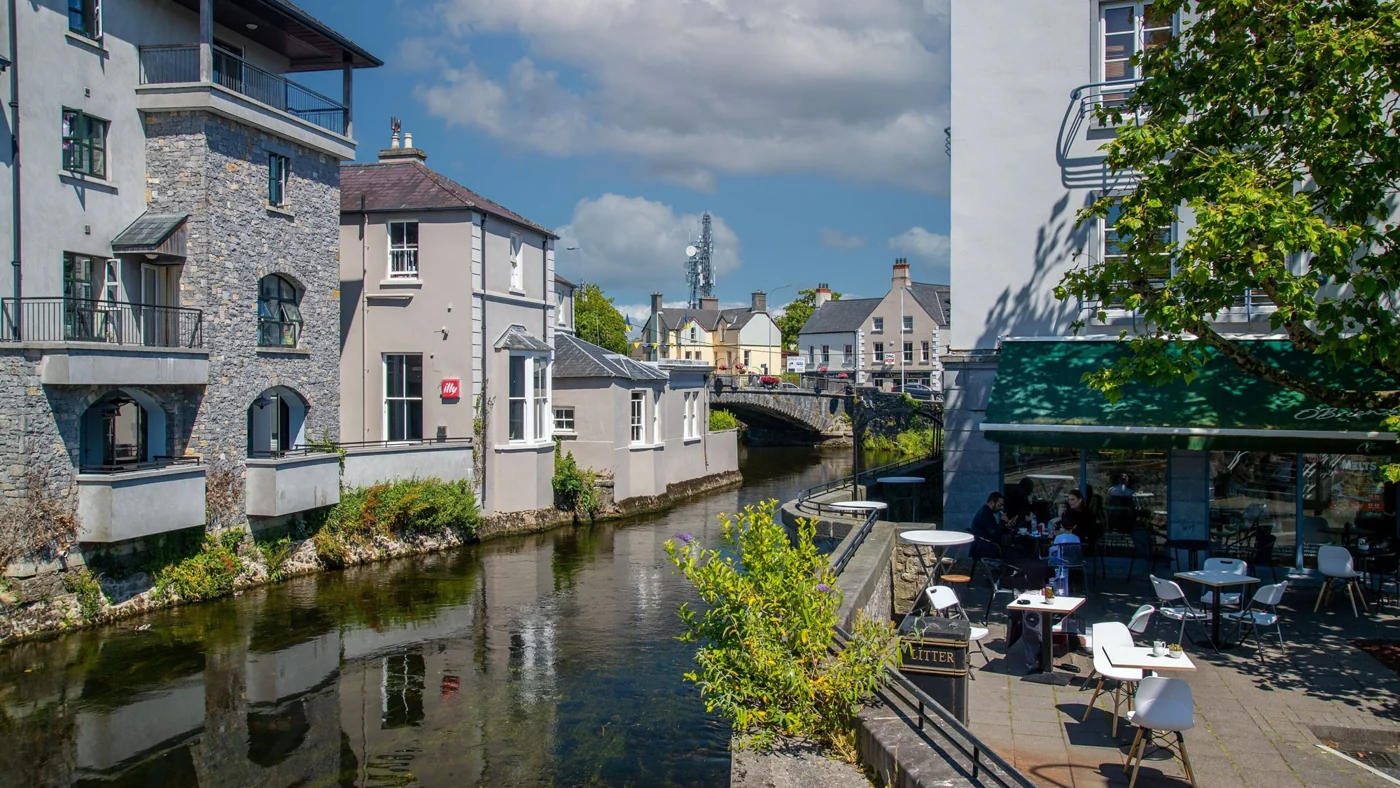 Riverside buildings and outdoor café tables in Ennis, County Clare